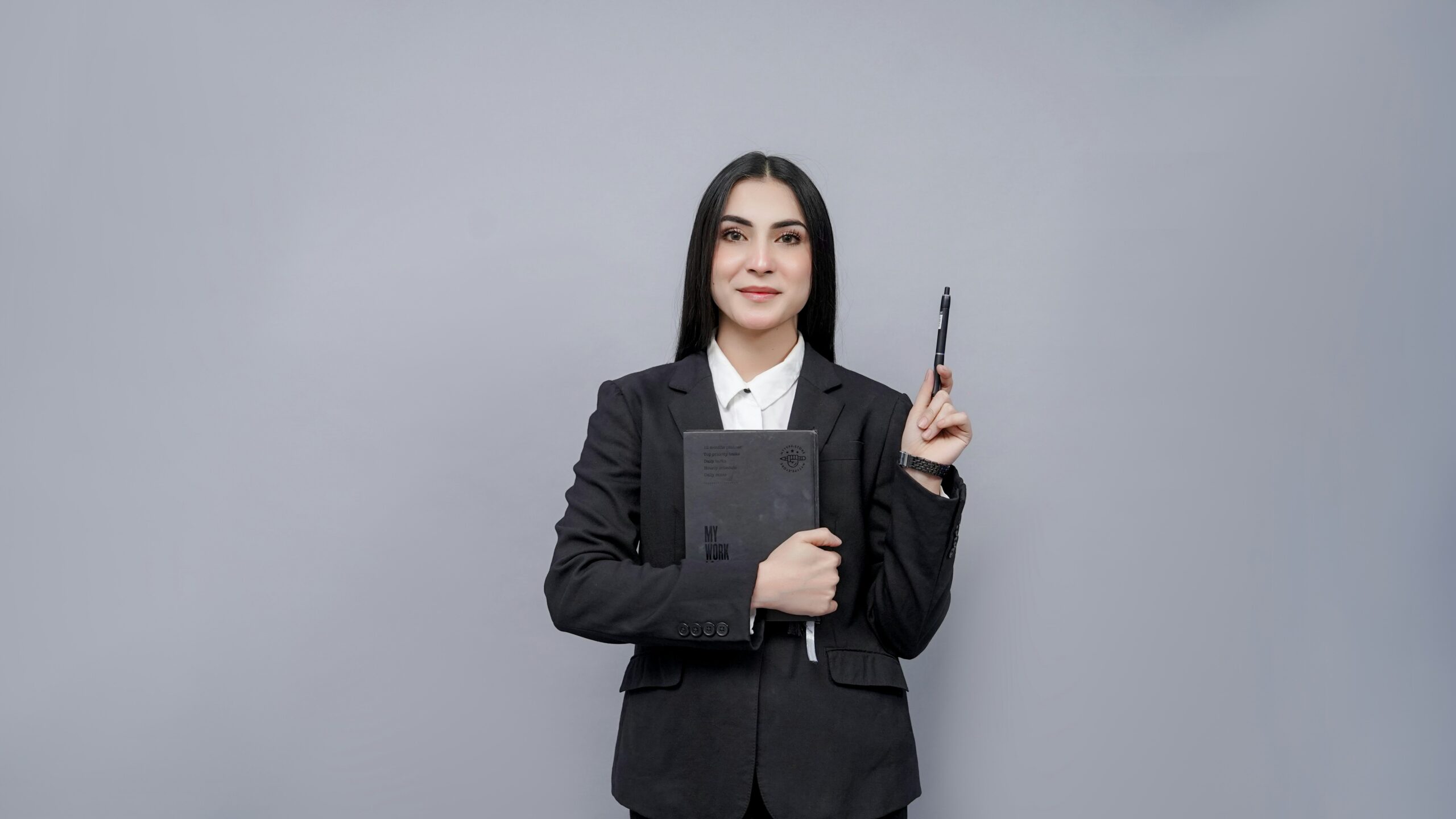 Management professional in a business suit holding a notebook and pen