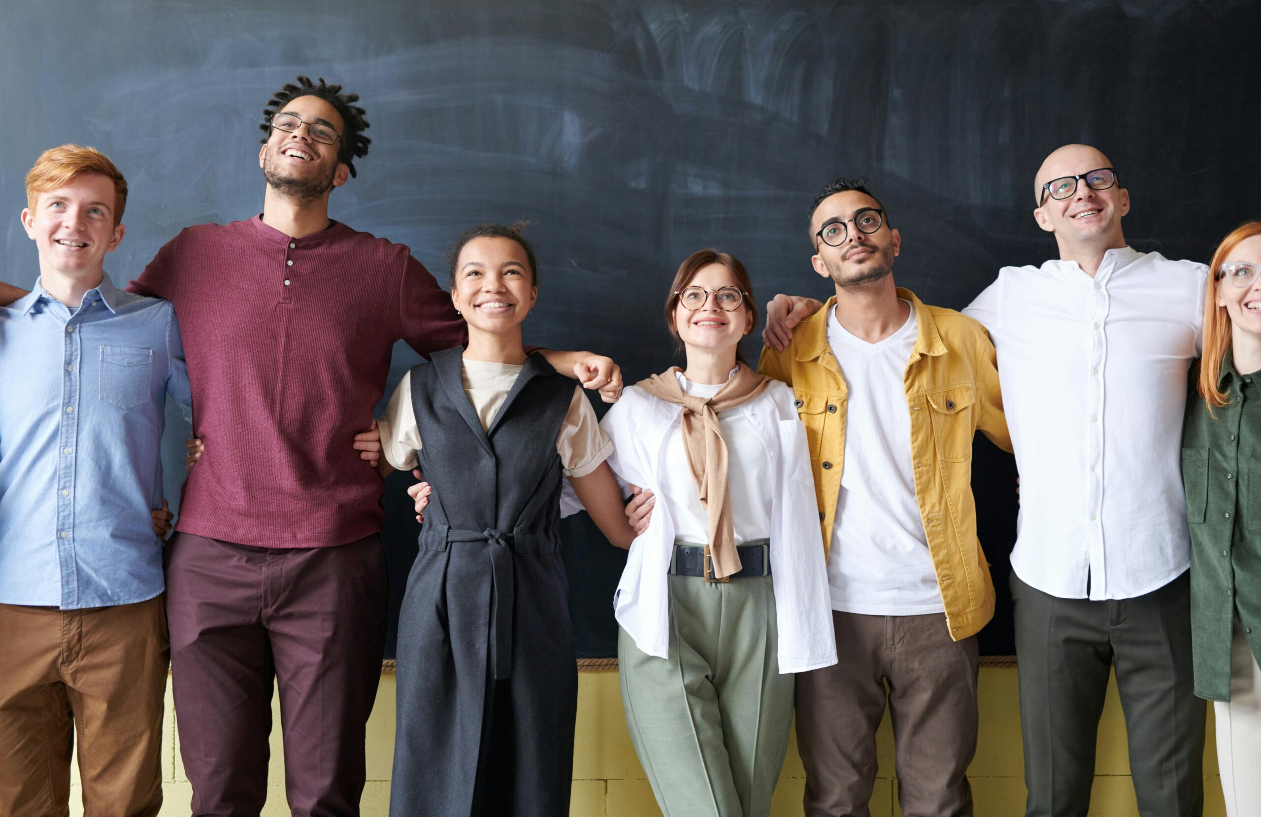 Marketing professionals standing in front of a chalkboard.